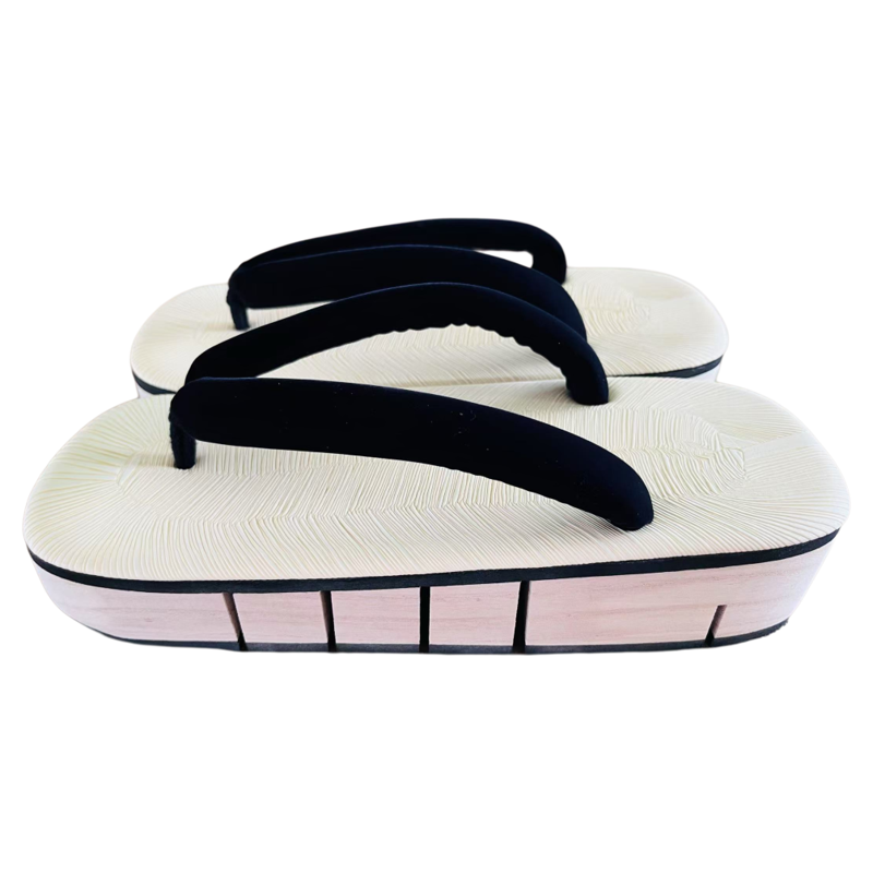 Pair of white sandals with black straps on a white background