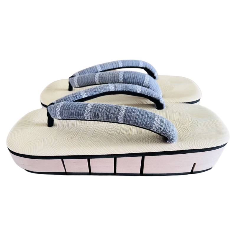 Pair of traditional Japanese sandals with gray straps on a white background