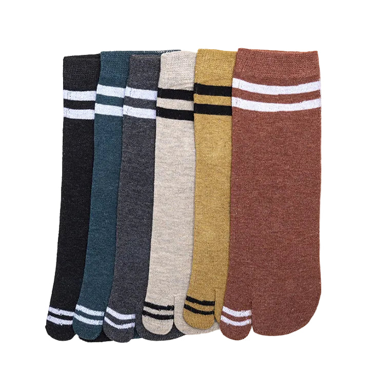 Set of six pairs of socks in various colors on a light gray background