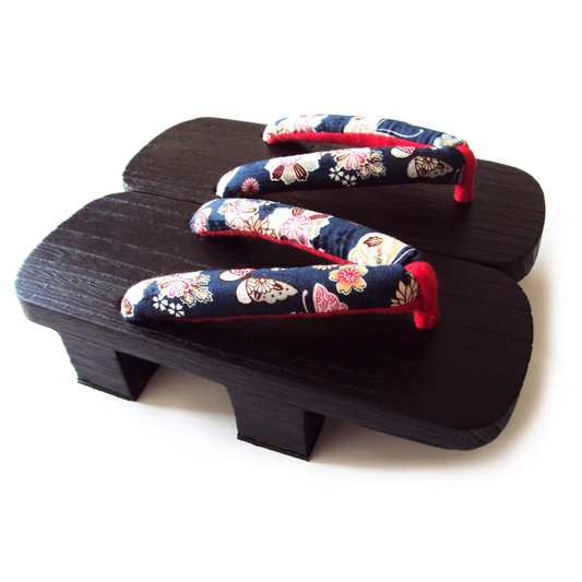 Pair of traditional Japanese sandals with floral straps on a white background