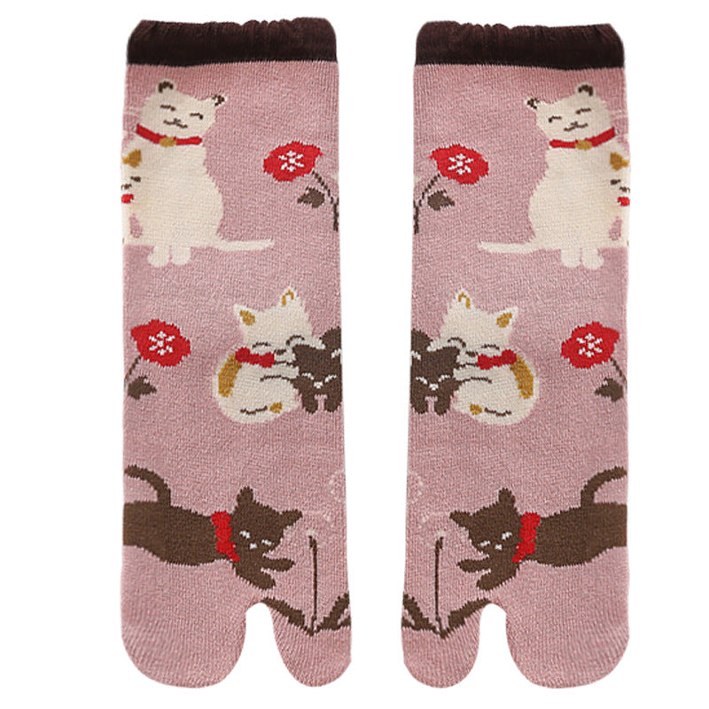 Pair of socks with cat and flower design on a pink background