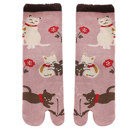 Pair of socks with cat and flower design on a pink background