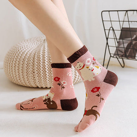 Two pairs of socks with floral patterns worn by people on a white background.