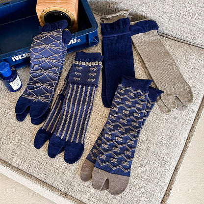 Pair of blue patterned socks with gray gloves on a textured surface