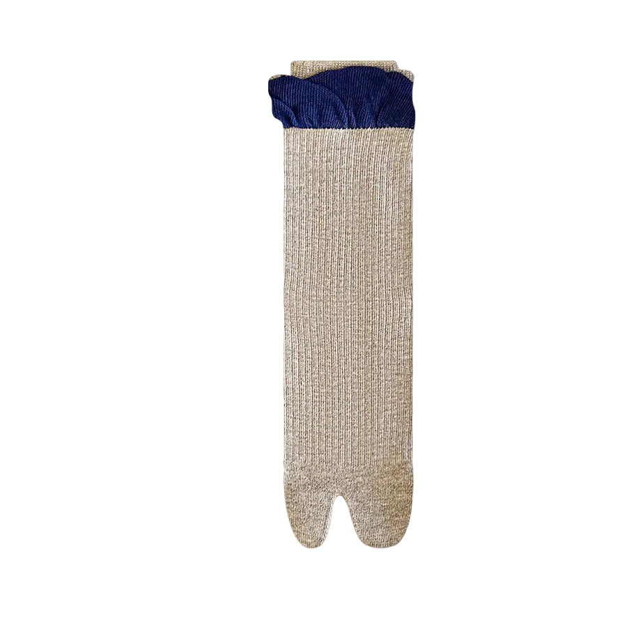 Pair of beige and blue footed socks on a light gray background 