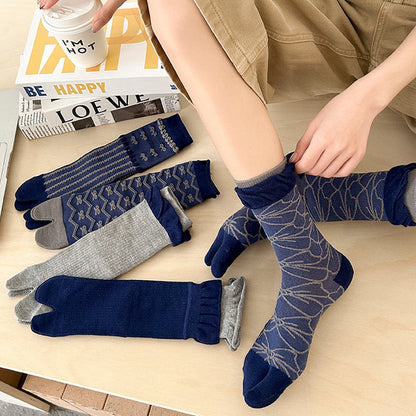 Person wearing and arranging various pairs of socks on a surface.