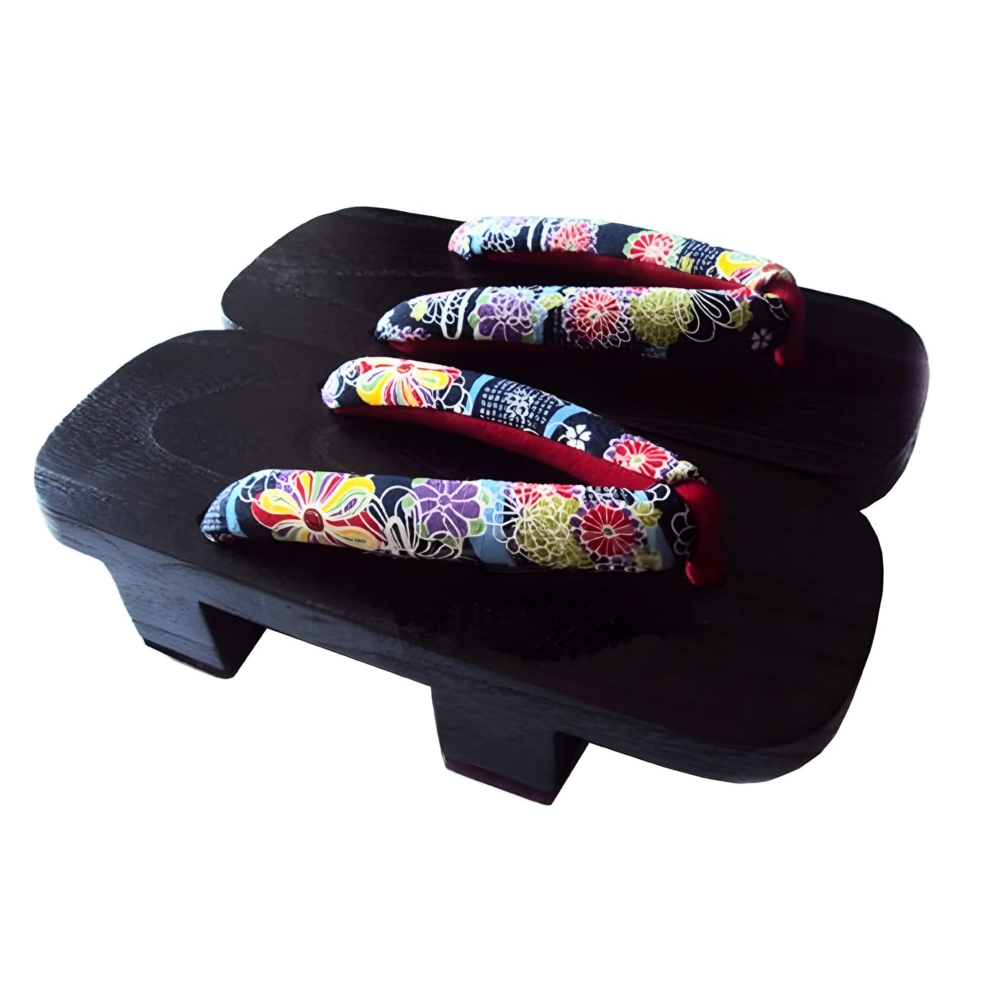 Pair of colorful floral-patterned sandals on a black wooden platform