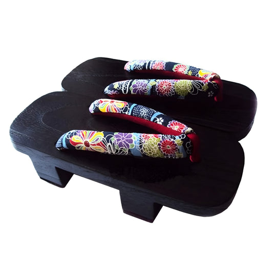Pair of colorful floral-patterned sandals on a black wooden platform