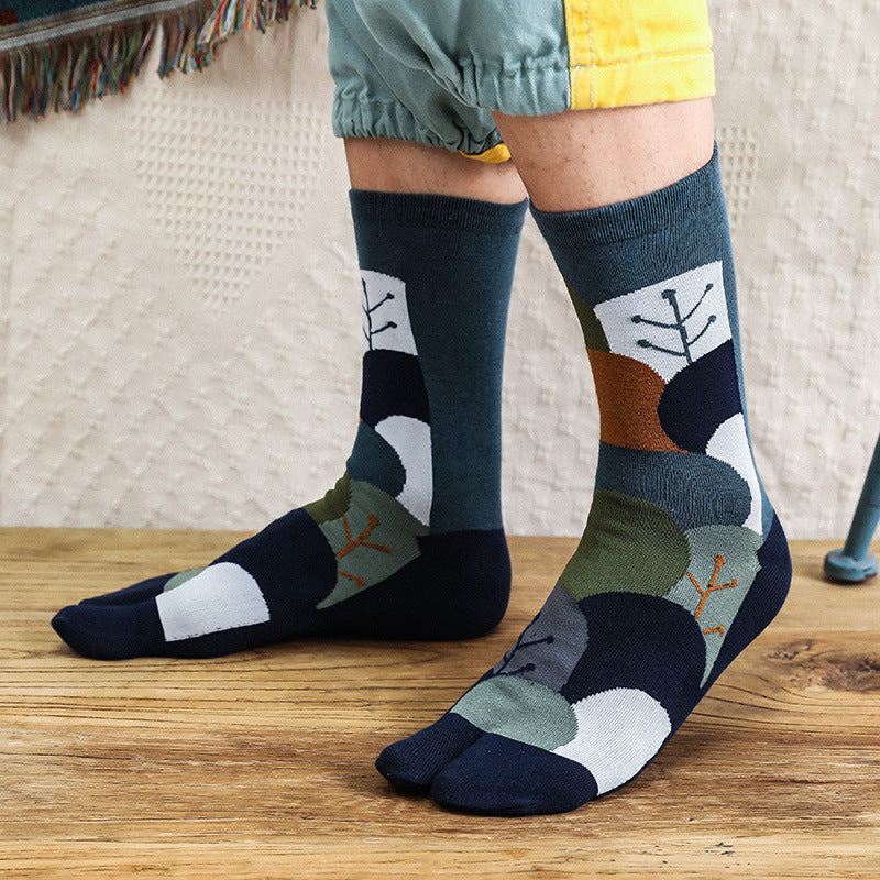 Person wearing patterned socks on a wooden floor with a neutral background