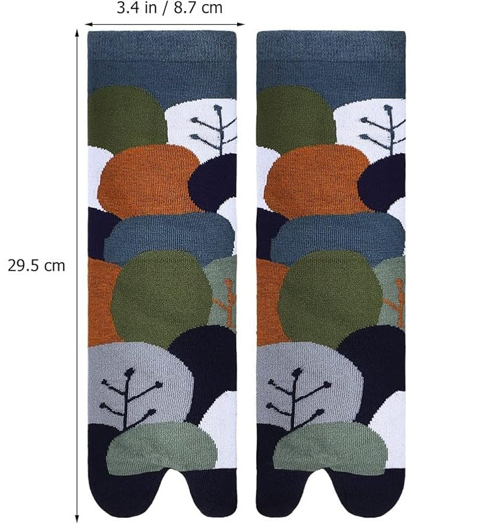 Pair of socks with a pattern of trees and leaves on a white background