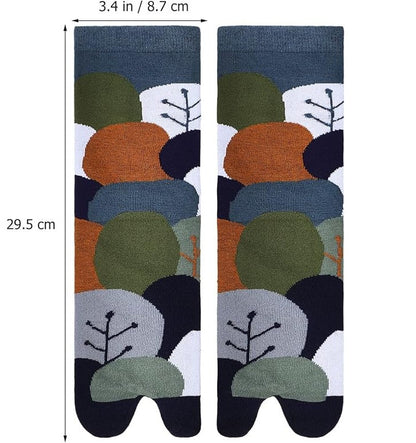 Pair of socks with a pattern of trees and leaves on a white background