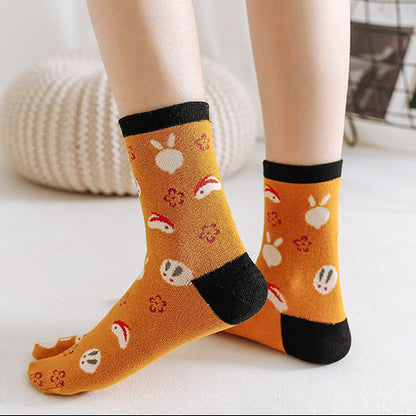 Two pairs of socks with cartoon designs on a light background.