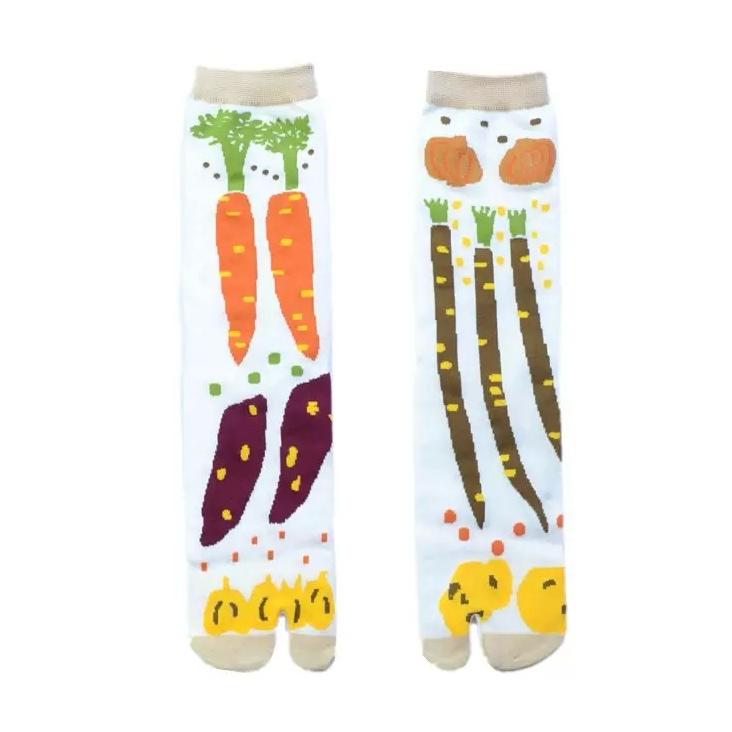 Two pairs of socks with vegetable designs on a white background